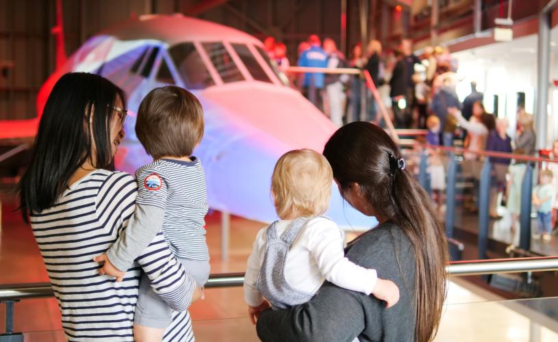 Two mothers and their children looking at the nose of Concorde Alpha Foxtrot in the Concorde Hangar at Aerospace Bristol - credit Aerospace Bristol