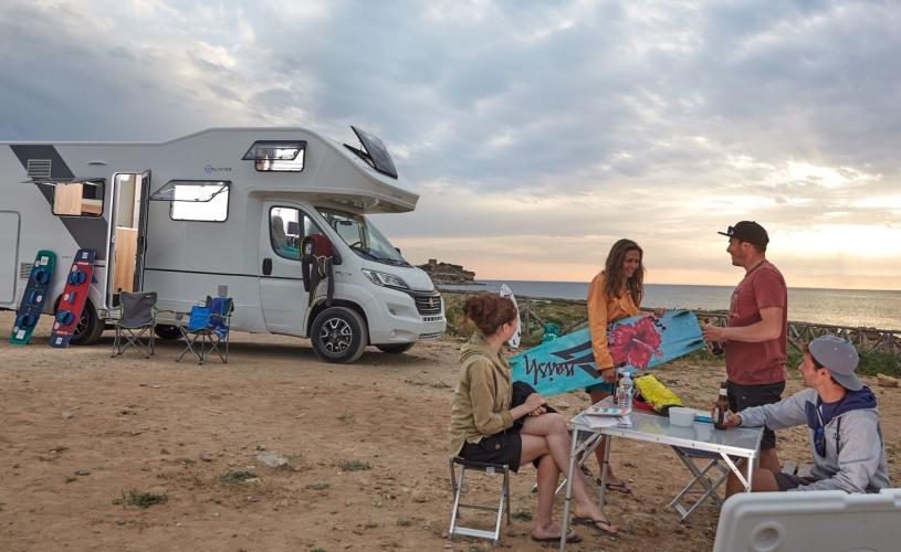 Campervan and family on beach - credit Motorhome Holiday Co