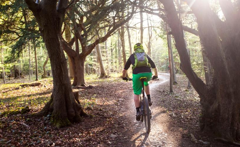 A man mountain biking on an off-road trail in Bristol