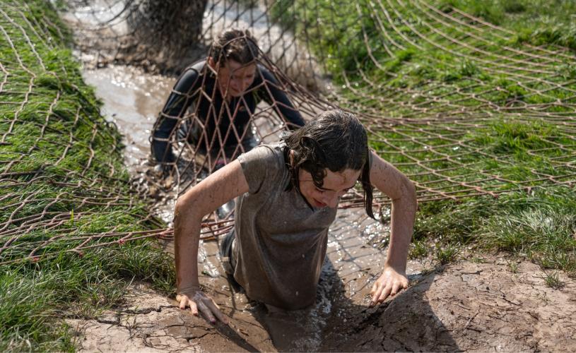 A group of people tackling the muddy assault course at Mendip Activity Centre near Bristol - credit Mendip Activity Centre