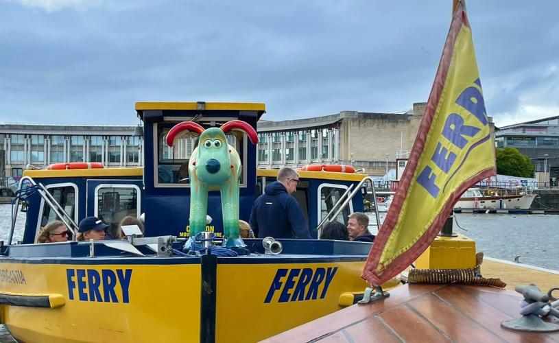 A yellow Bristol Ferry boat with a green gromit on the bow