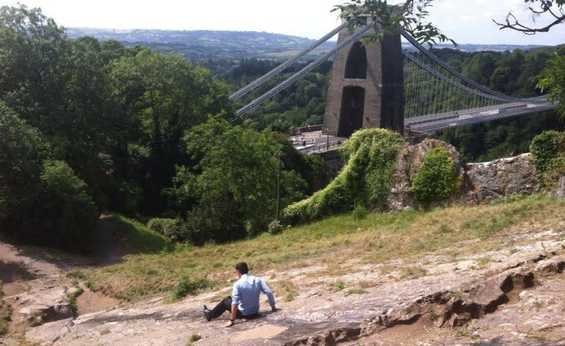 A man sliding down the rock slide in Clifton, West Bristol - credit Visit Bristol
