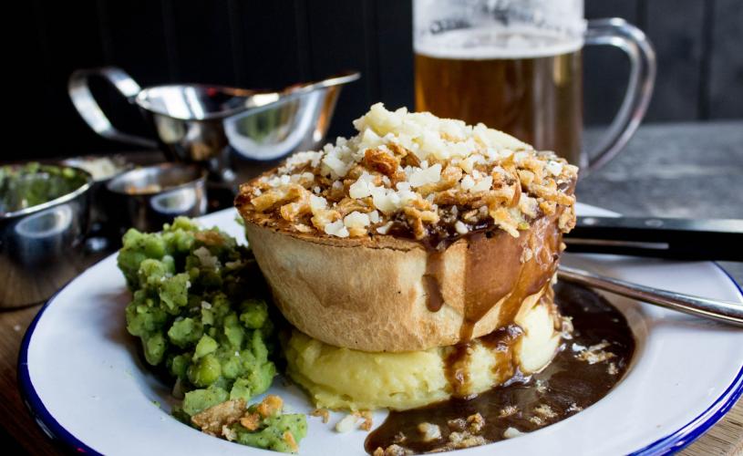 Pie, mash, peas and gravy on a plate