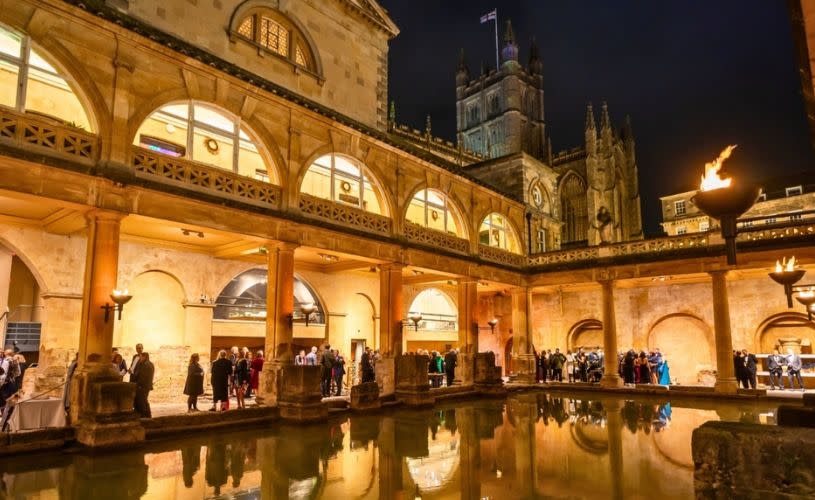 Roman Bath Evening Drinks Reception with torches lit.