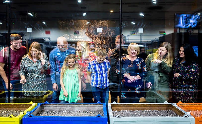 A group of people looking at one of the exhibits at The Royal Mint Experience in Llantrisant, South Wales, near Bristol - credit The Royal Mint Experience