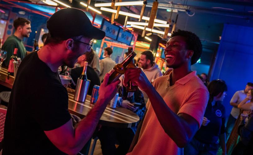 Sixes Social Club - Two Men clinking beers