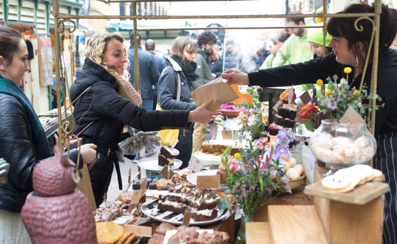 People buying food at St Nicholas Market in Bristol's Old City - credit Paul Box