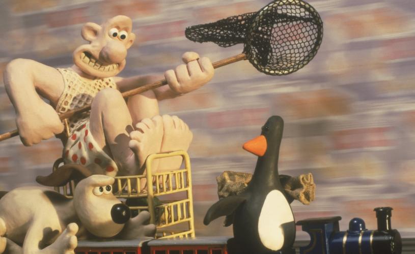 A still of the famous Claymation characters Wallace & Gromit chasing a penguin in the 1993 film The Wrong Trousers - credit Aardman Animations