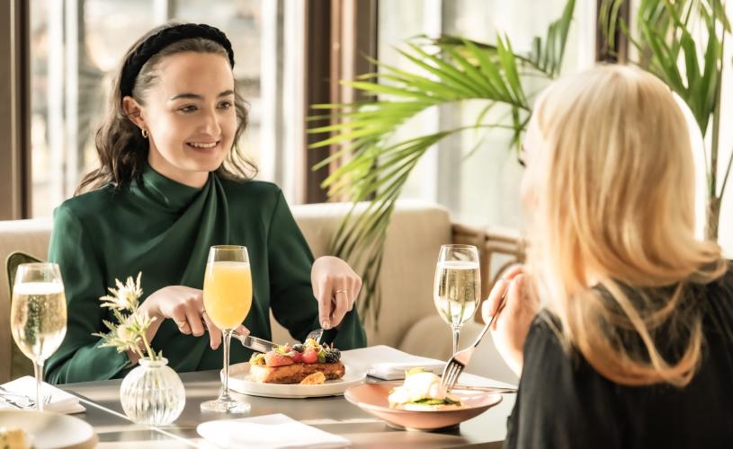 Two women eating brunch at Rick's Bar on Bristol's Harbourside - credit Rick's
