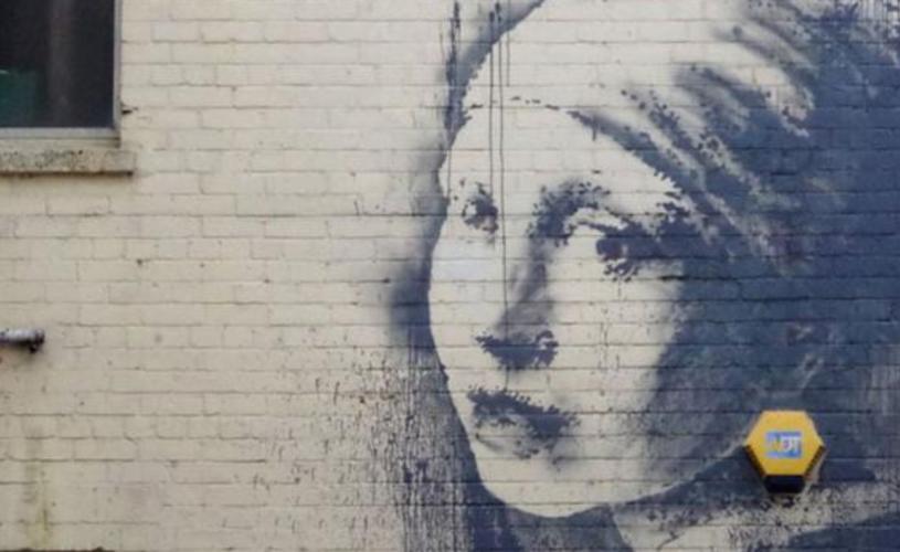 Banksy's 'The Girl With The Pierced Eardrum' street art on Bristol's Harbourside - credit Visit Bristol