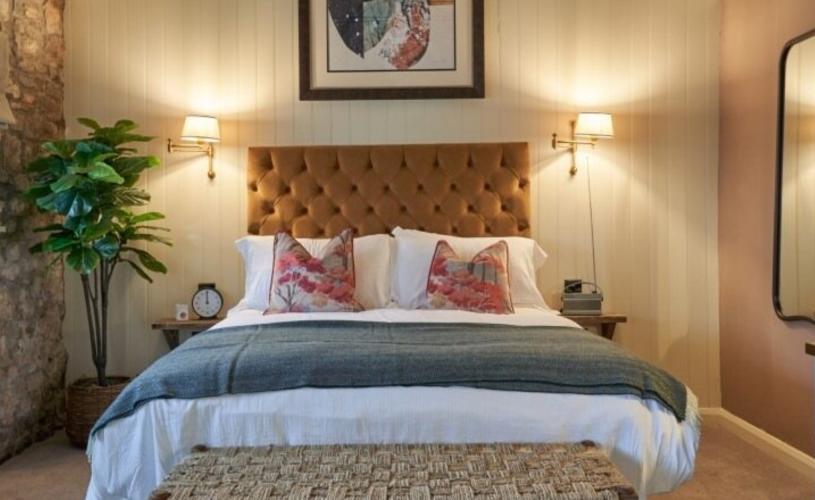 A large bed in a bedroom at The Langford - Credit The Langford