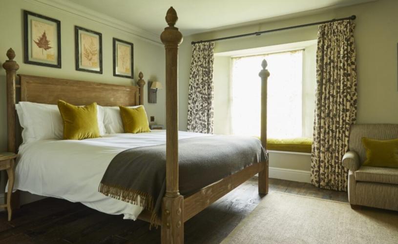 A bedroom with posts at The Pig Near Bath
