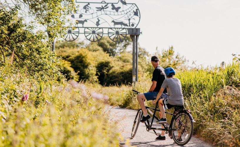 Two people on a tandem bike