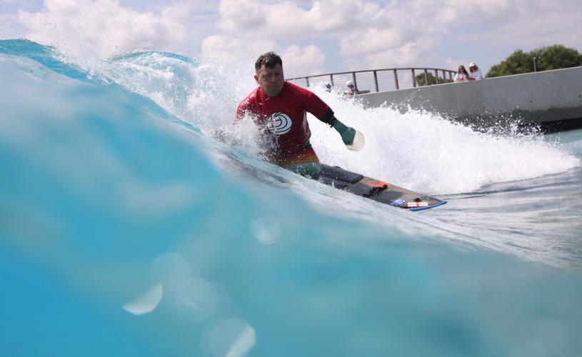 A surfer taking part in adaptive surfing at The Wave inland surfing lake near Bristol - credit The Wave