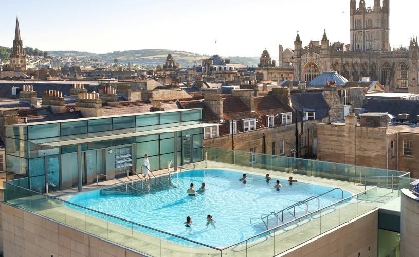 An aerial view of the rooftop pool at the Thermae Bath Spa in central Bath near Bristol, with Bath's skyline in the background