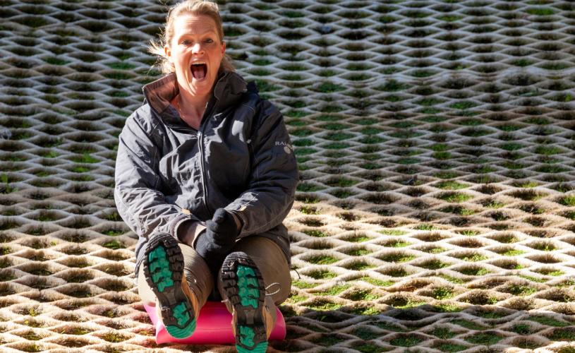 A woman tobogganing on the slope at Mendip Activity Centre, near Bristol - credit Mendip Activity Centre