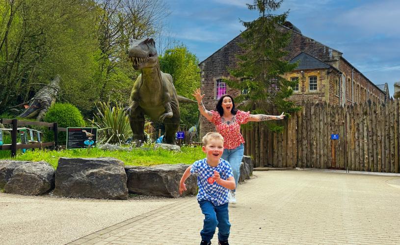 Mother and son with dinosaur at Wookey Hole near Bristol - credit Wookey Hole