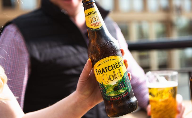 Person holding bottle of Thatchers Gold cider - credit Thatchers Cider