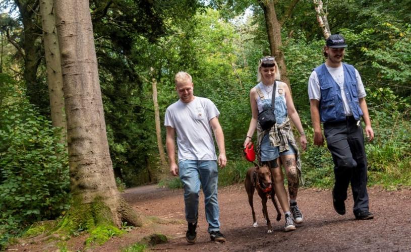 People walking a dog in Leigh Woods in Bristol - credit Forestry England