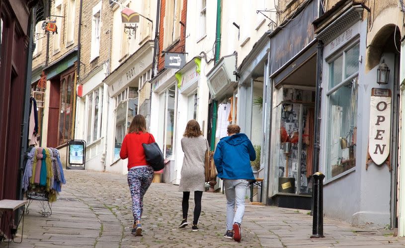 People walking up hill in Frome - credit Visit West