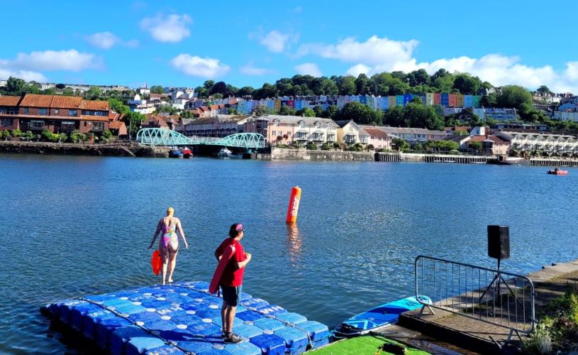 Swimming in Bristol Harbourside - one person in a sailing boat, and another two people in a sailing boat chatting - Credit All Aboard Watersports