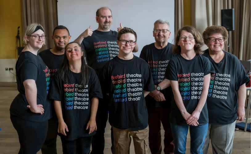 A group of people wearing black t-shirts that say Firebird Theatre Company