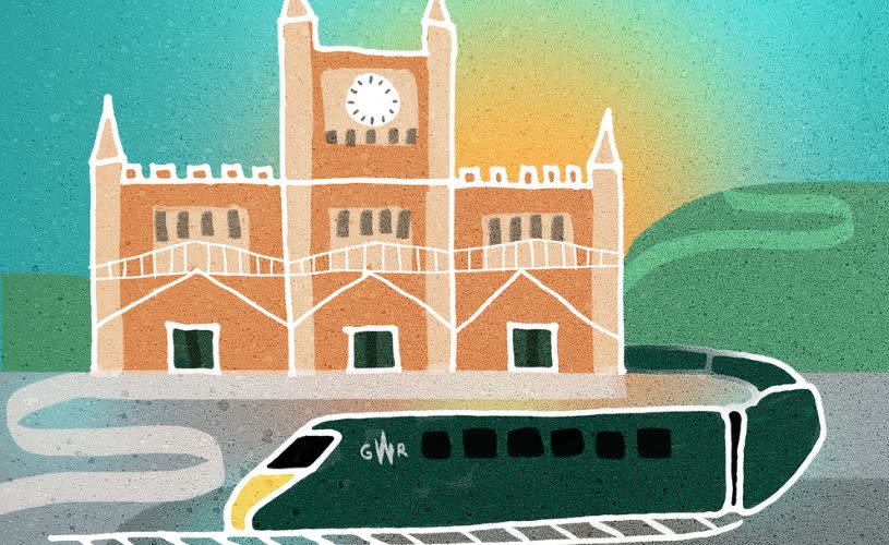 Illustrated artwork of a green GWR train arriving at Bristol Temple Meads railway station, with the station's iconic clock tower and historic façade set against a colourful sunrise sky.