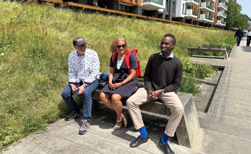 3 people sat on a bench near Bristol Harbour