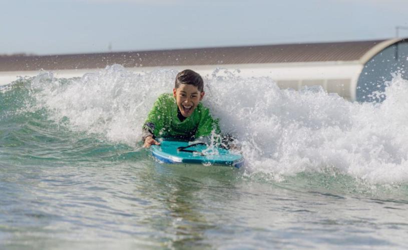 Child body boarding at The Wave