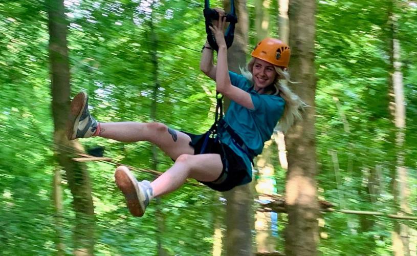 Person on zip line in tree tops - credit Adventure Bristol