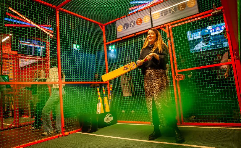 Sixes Social Cricket Batting Cages with woman