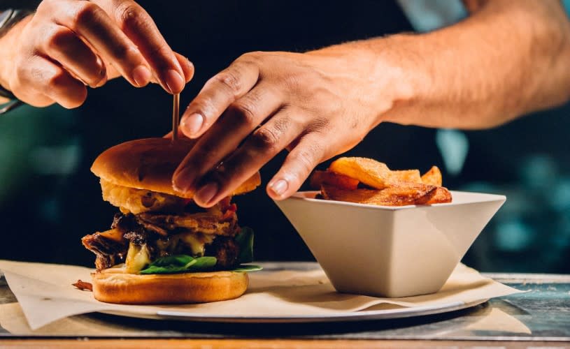 Person handling burger