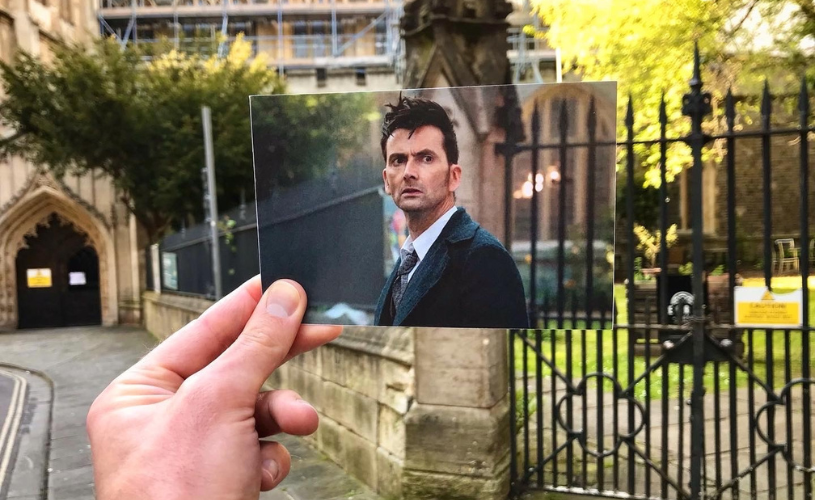 A view of St Stephen's Church in Bristol's Old City, with a hand holding a photograph of actor David Tennant filming one of the 2023 Doctor Who specials in the same spot - credit Logan Walker