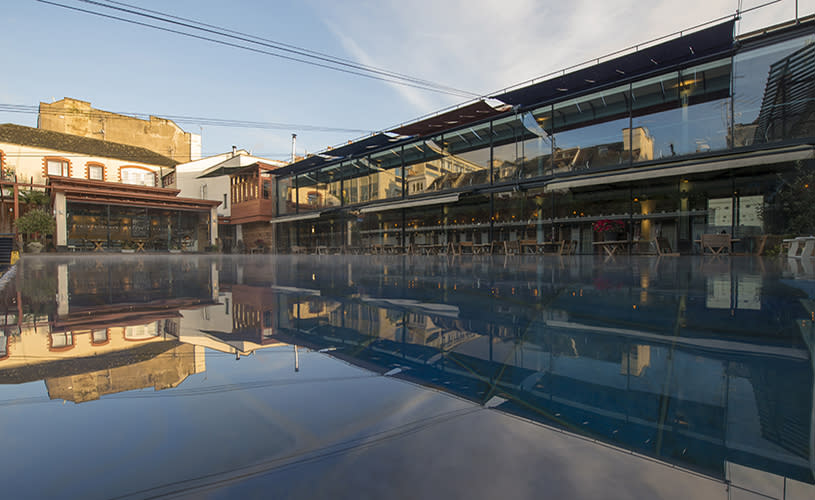 Outdoor swimming pool and glass-fronted restaurant