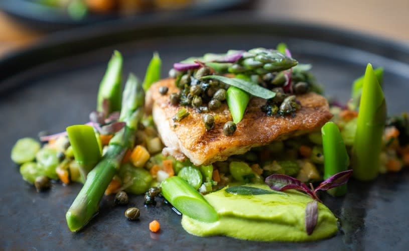 A plate of food featuring green vegetables and salmon - Credit The Square Kitchen