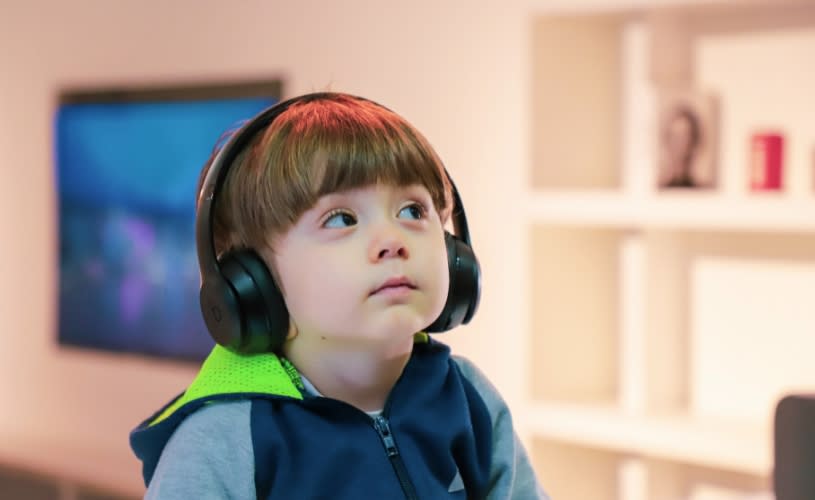 A small child wearing ear defenders