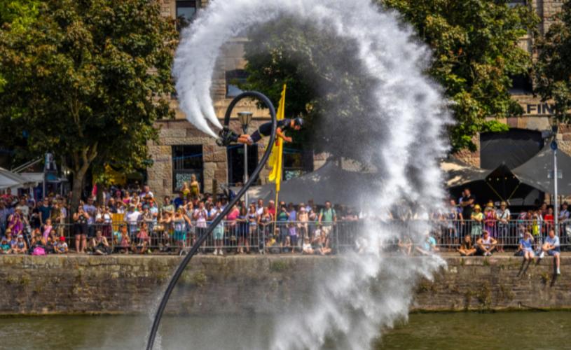 A man wearing a water-powered jetpack performing stunts on Bristol's Harbourside during the Bristol Harbour Festival