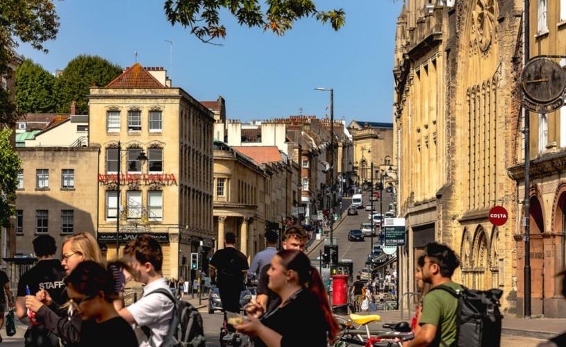 A view from the bottom of Park Street in central Bristol looking uphill with people in the foreground
