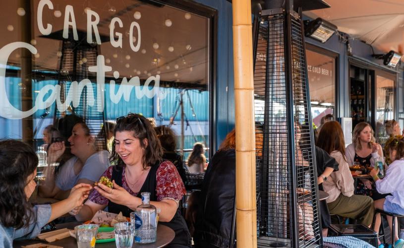 People dining outside Cargo Cantina in Wapping Wharf on Bristol's Harbourside - credit Hey What