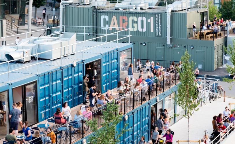 An aerial view of people dining alfresco at Wapping Wharf on Bristol's Harbourside - credit Jon Craig