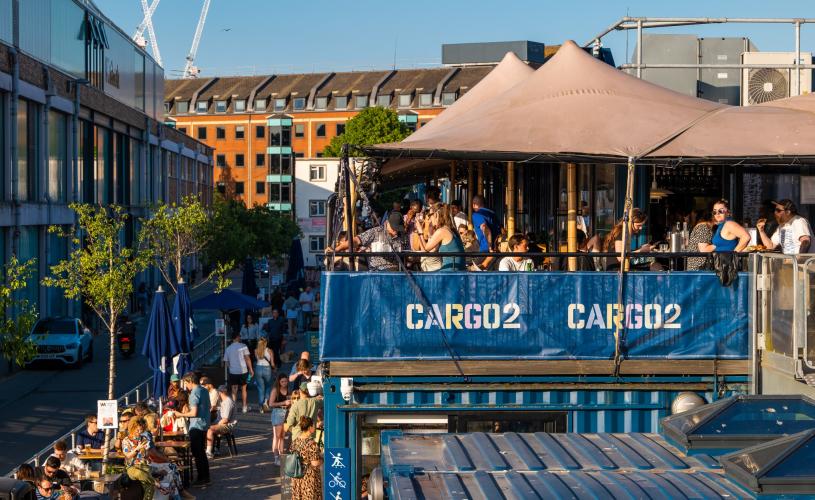 People dining alfresco at Wapping Wharf on Bristol's Harbourside - credit Hey What