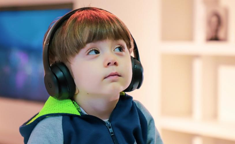 A young boy wearing headphones at the We The Curious science centre in Bristol - credit We The Curious