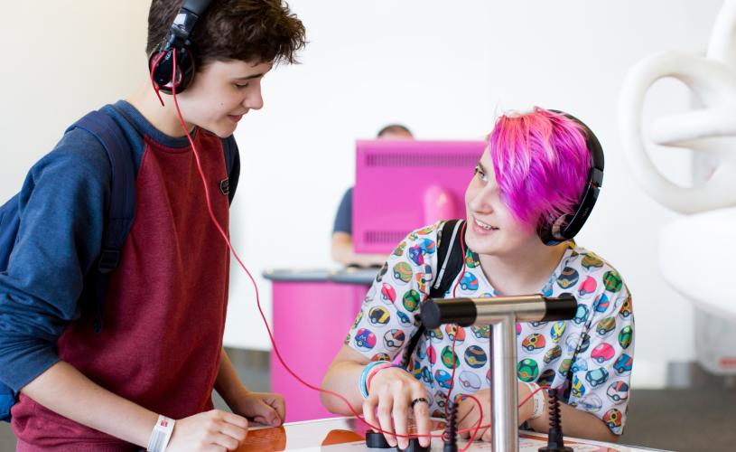 A boy wearing headphones trying one of the activities at the We The Curious science centre in Bristol - credit Paul Blakemore