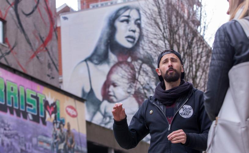 One of the guides from the 'Where The Wall' street art tour in Nelson Street, central Bristol - credit Paul Box