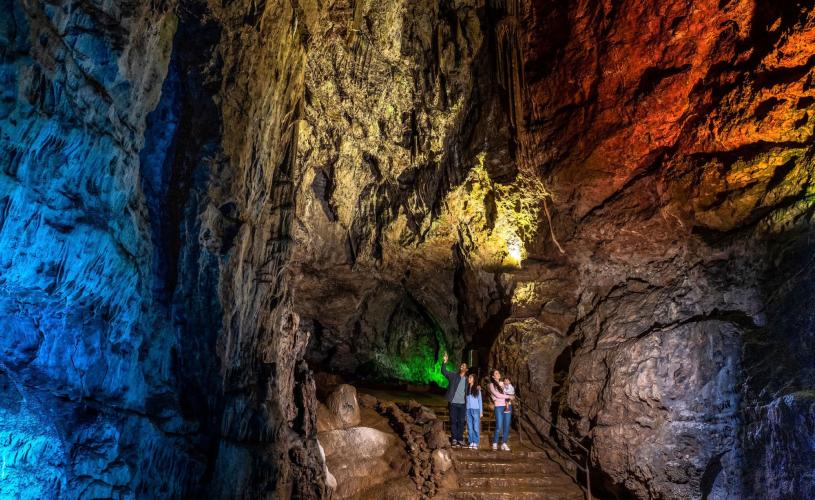 A family in a cave at Wookey Hole near Bristol - credit Wookey Hole