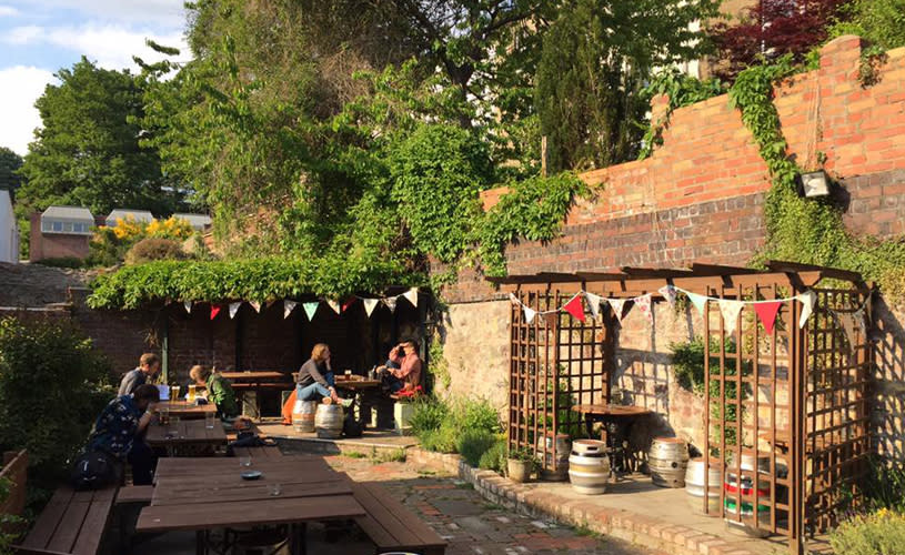 A beer garden with red and white bunting - Credit The Hope and Anchor