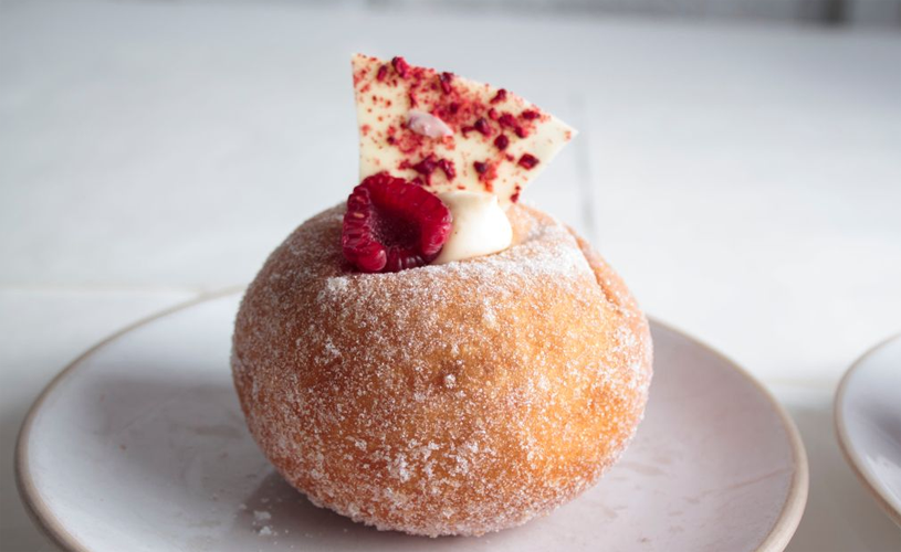 A sourdough donut with a raspberry on top - Credit Pinkmans