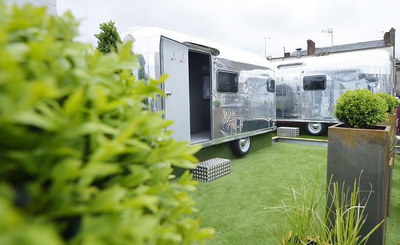 Retro rocket caravans surrounded by plants