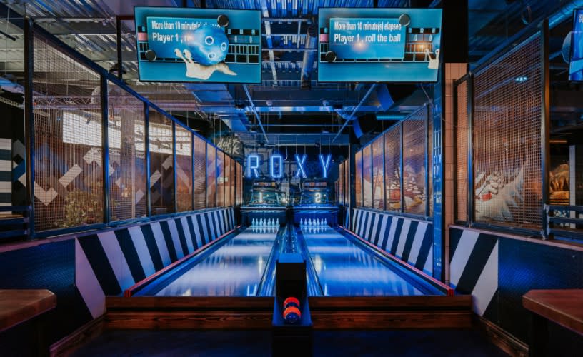 Bowling alleys lit up with blue neon