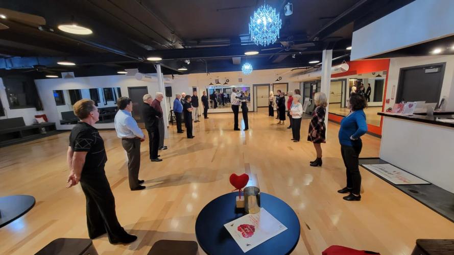 Two lines of people facing each other for dance lesson